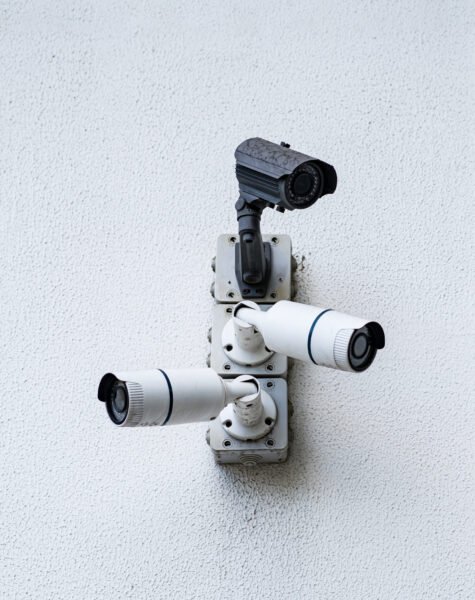 Security cameras on white modern building, technology concept