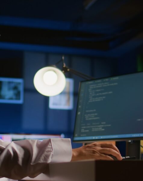 Arab technician writing script code on computer screen inputting commands on terminal. Middle Eastern teleworking employee at home working on fixing company internal database errors